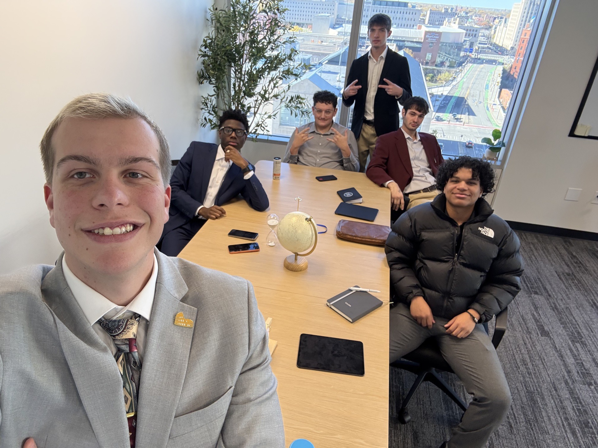 Tiber and Laurel team meeting in the Rochester office with city skyline views